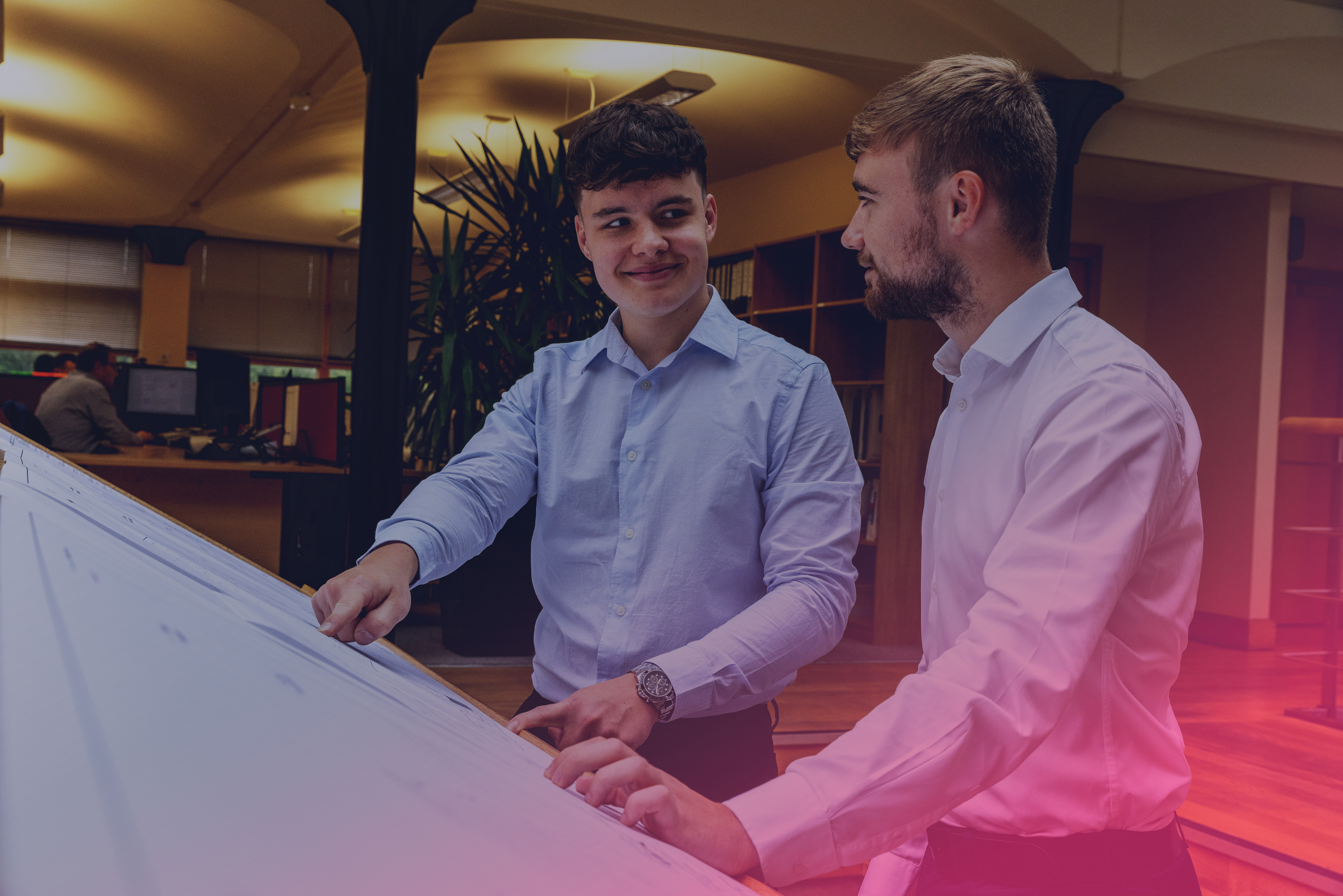 Two guys poiting at a paper