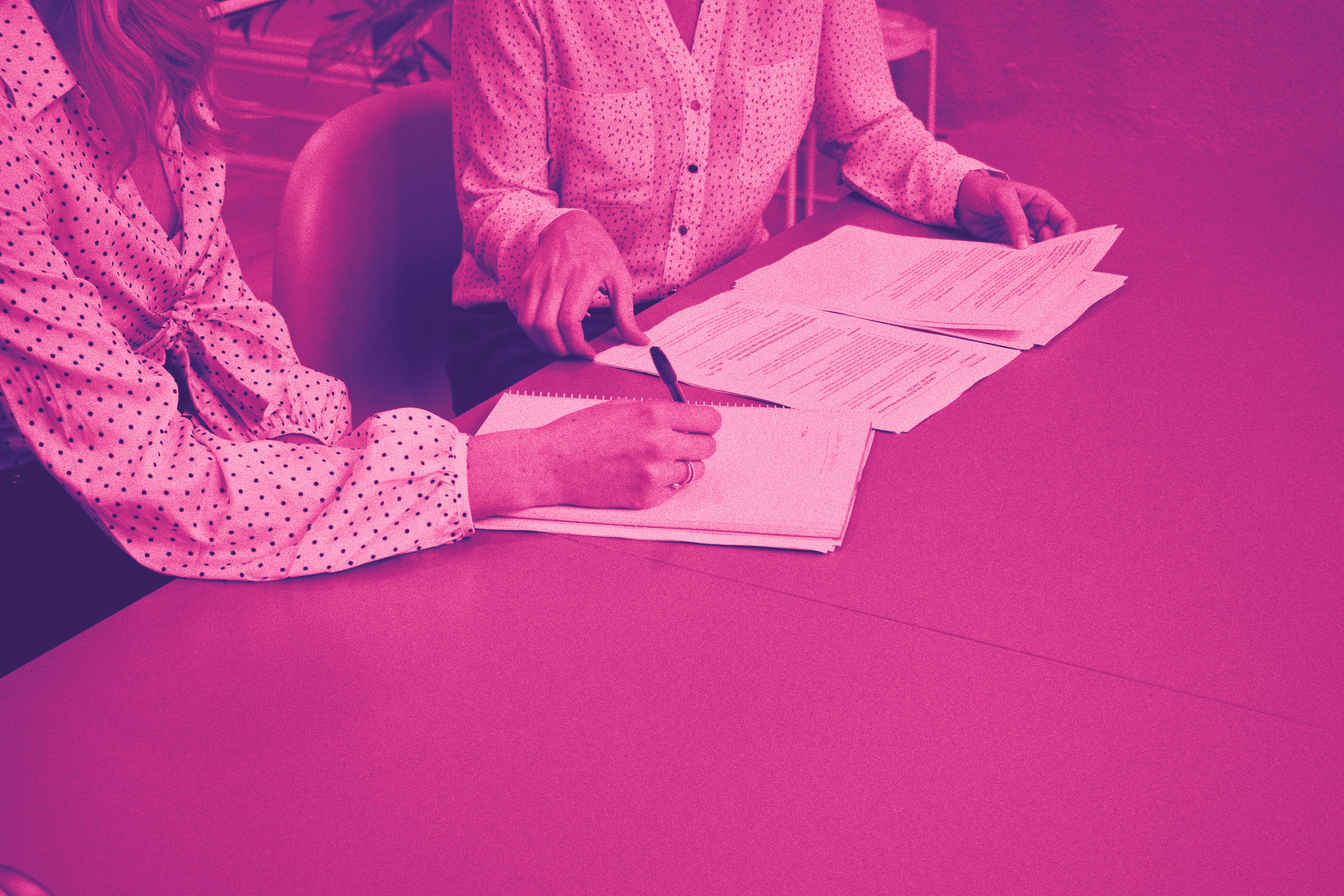 Two people at the table sign a contract.